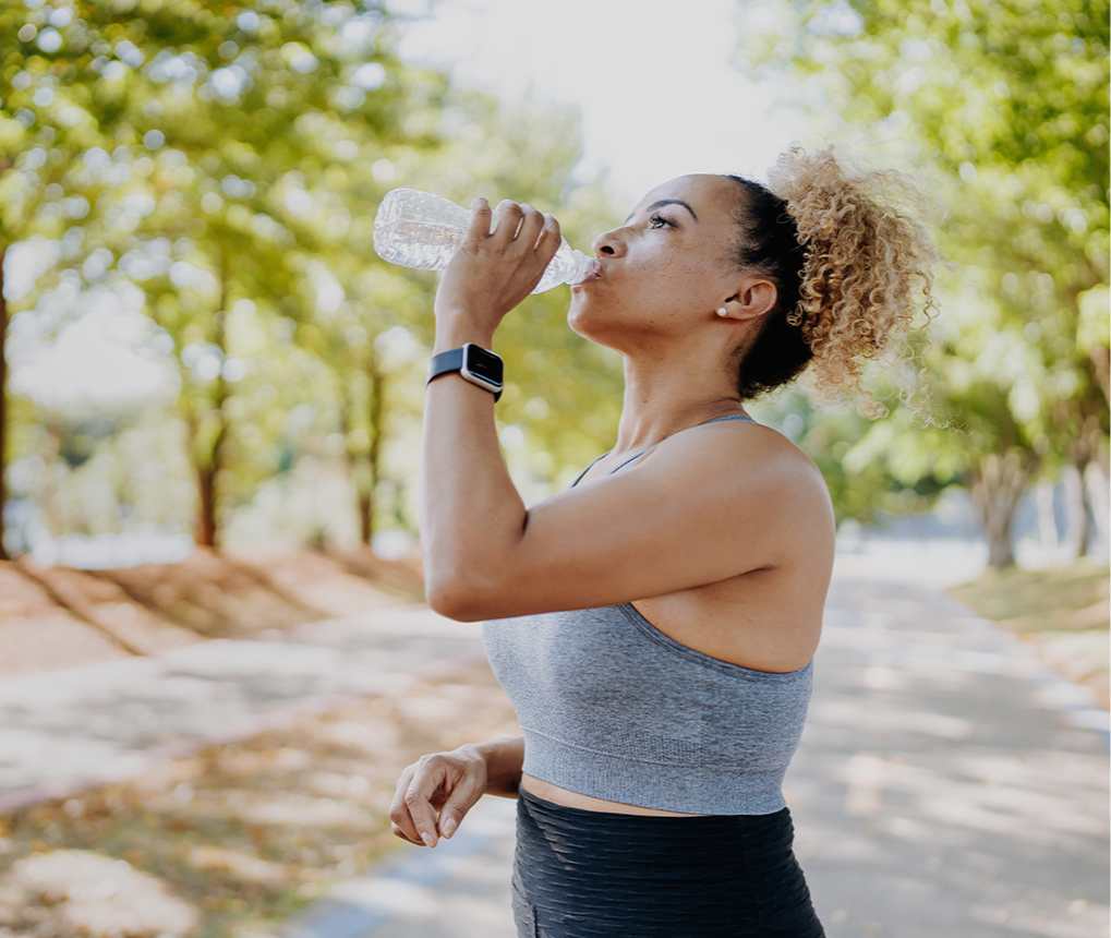 Woman taking a water break outdoors