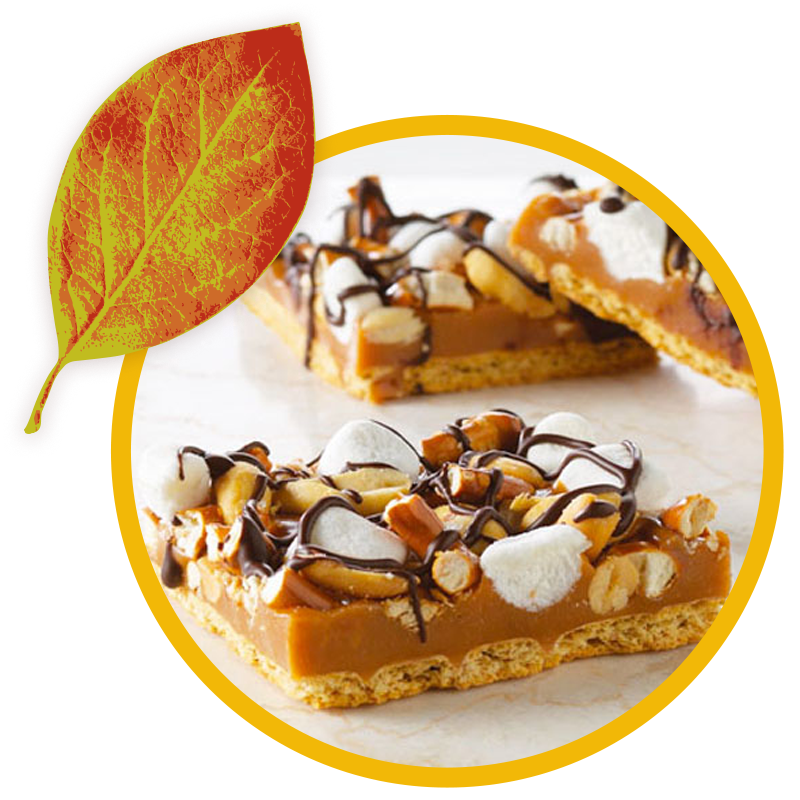 Caramel bars topped with peanuts, mini marshmallows, and a chocolate drizzle over a graham cracker crust, next to a fall leaf graphic.