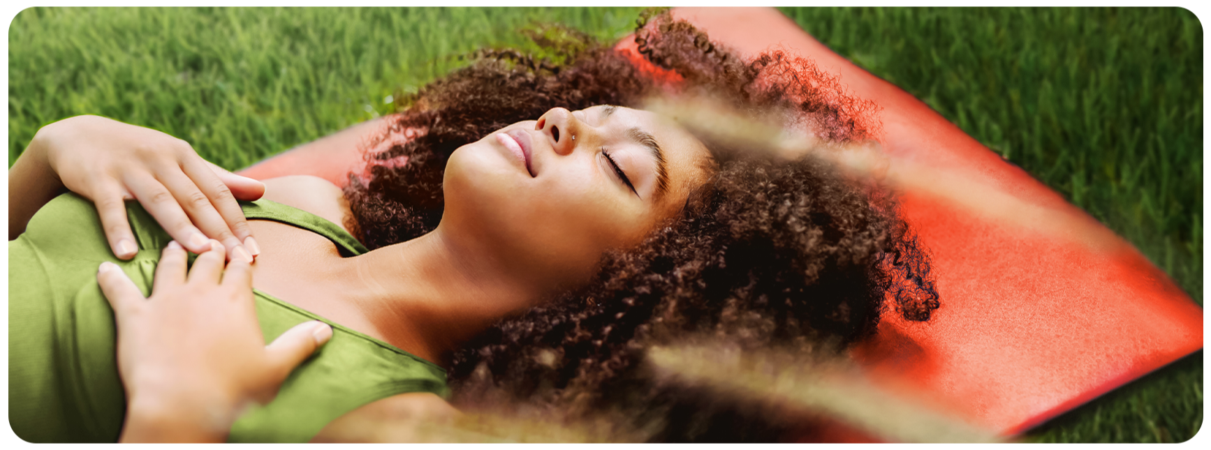 Picture of woman lying on a mat in the grass