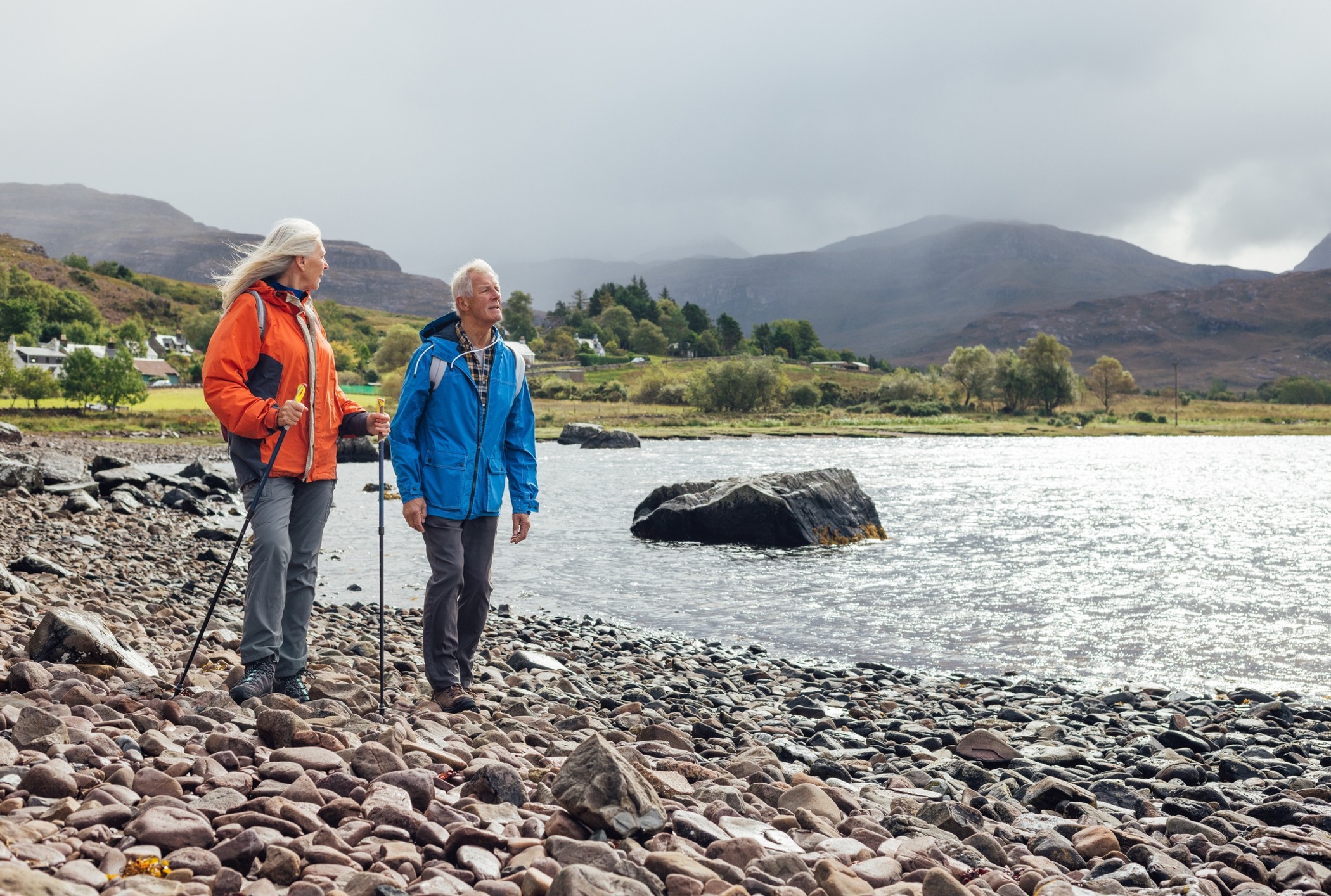 Elderly couple hiking by the water