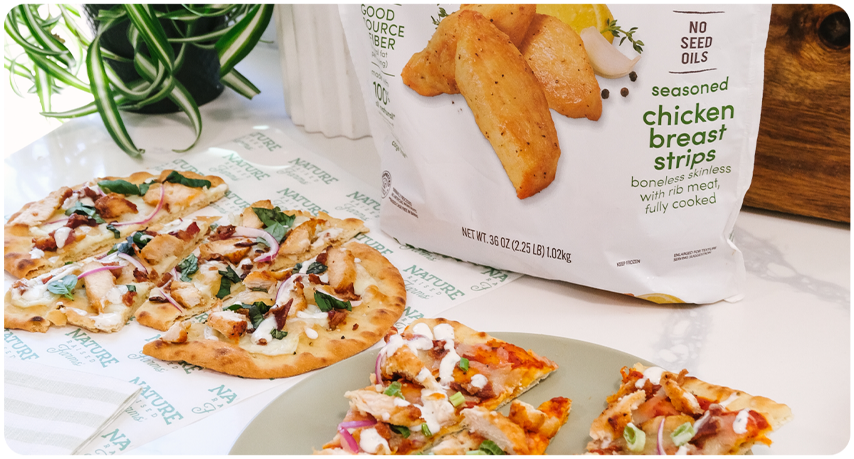 Chicken flatbread pizza on counter with Nature Raised Farms chicken breast strips