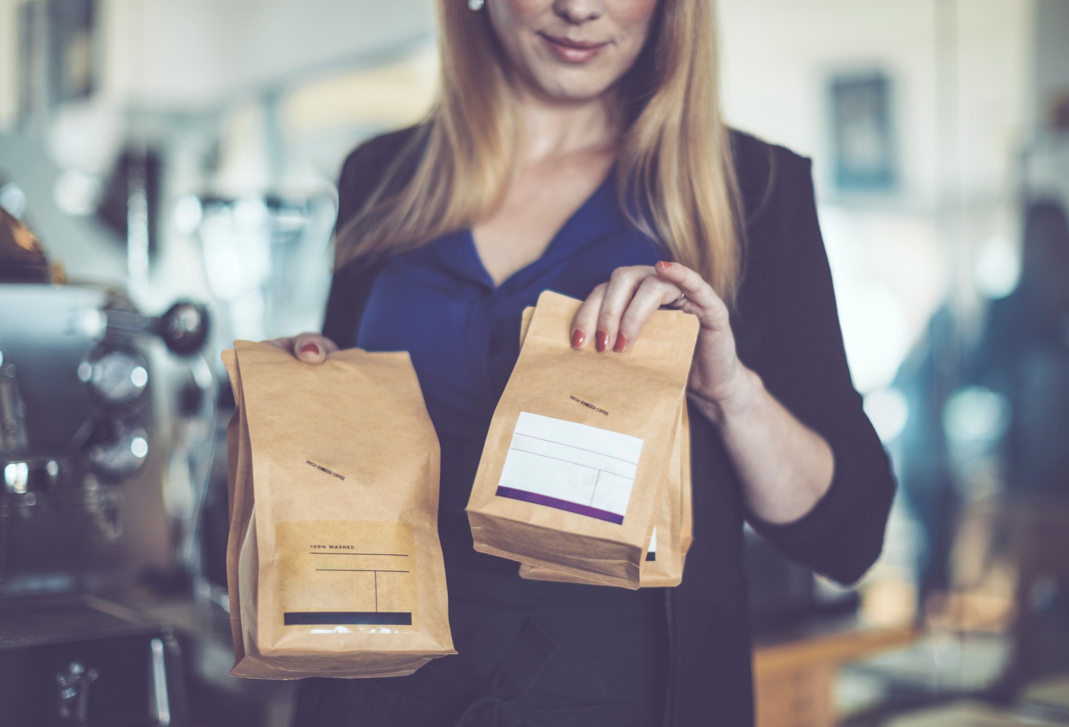 Woman holding bags of coffee beans