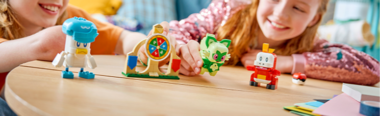 Two children playing with the Lego Pokemon Smart Play: Sprigatito, Fuecoco, and Quaxly battle set.