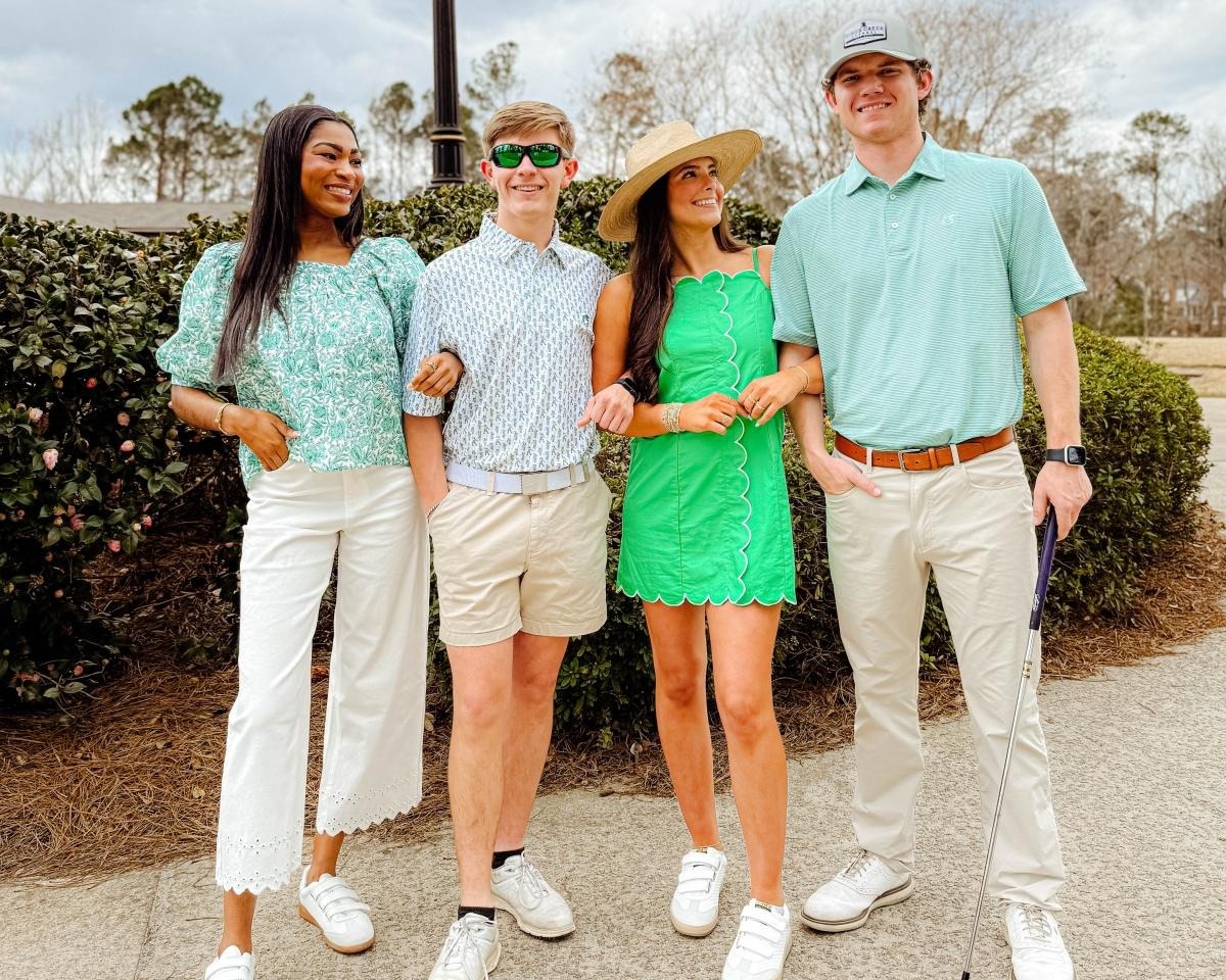 Four young people wearing golf outfits