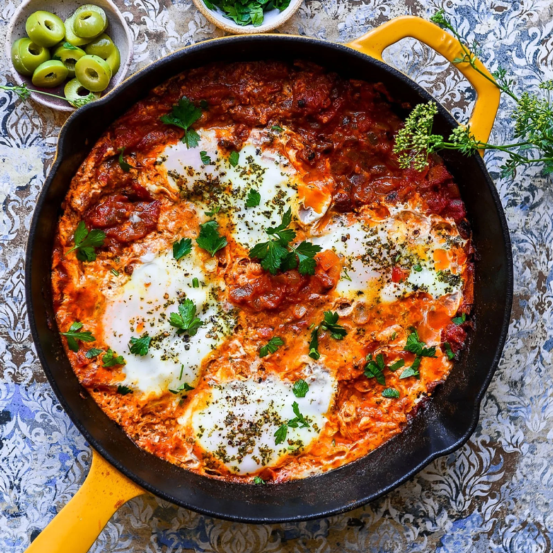 Shakshuka style eggs with tomatoes and white beans.