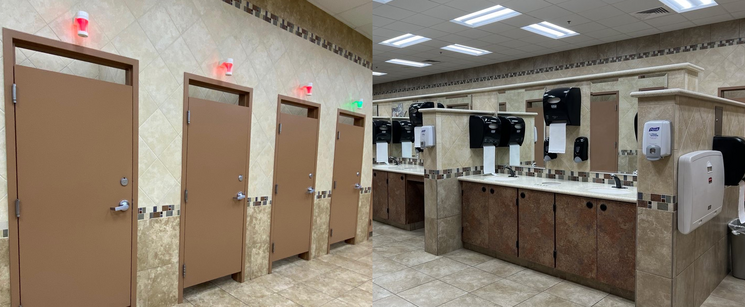 Clean, bright restroom with stalls and sinks.