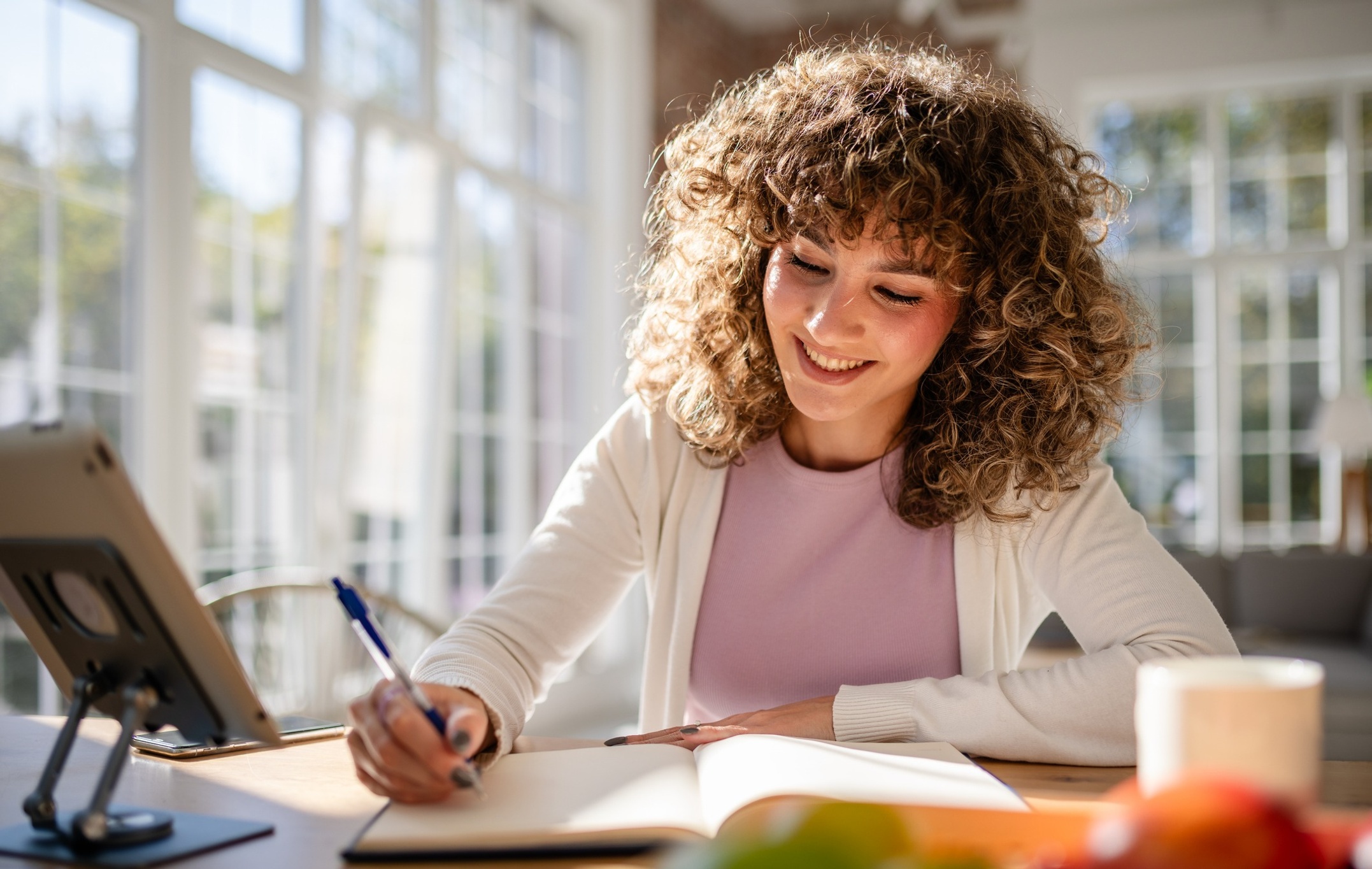 Woman journaling on a sunny day