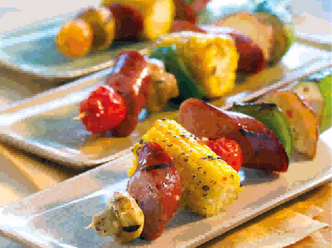 Zesty Italian Smoked Sausage Kabobs on white plates.