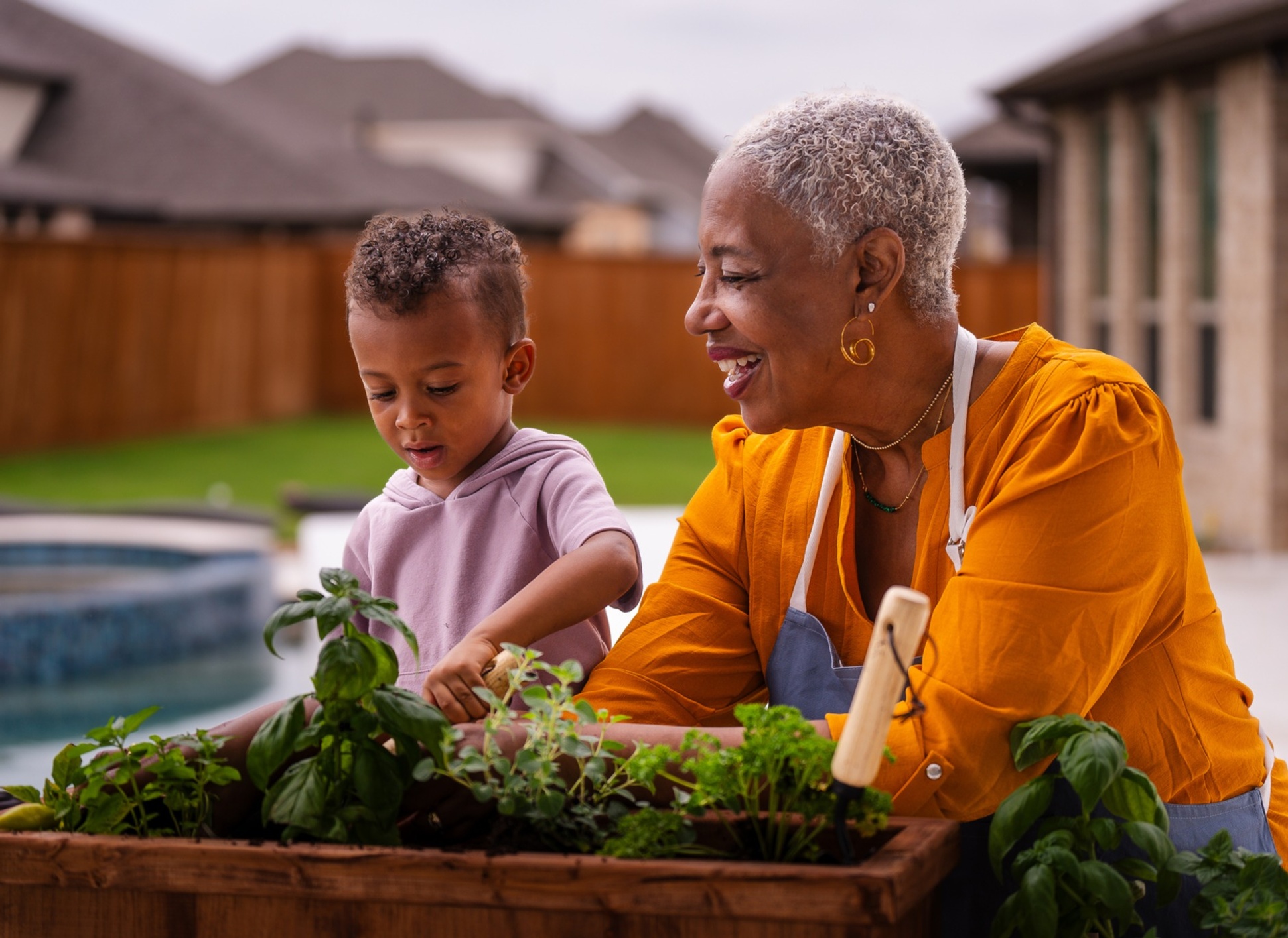Older woman gardening with a younger boy