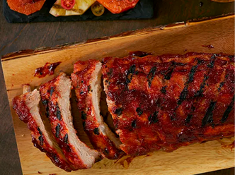 Brown Sugar and Chili Smoked Pork Baby Back Ribs on a wood board.