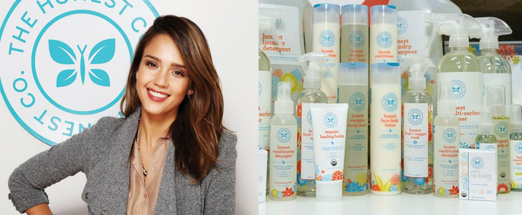 Jessica Alba posing next to a display of personal care products from her brand, The Honest Company.