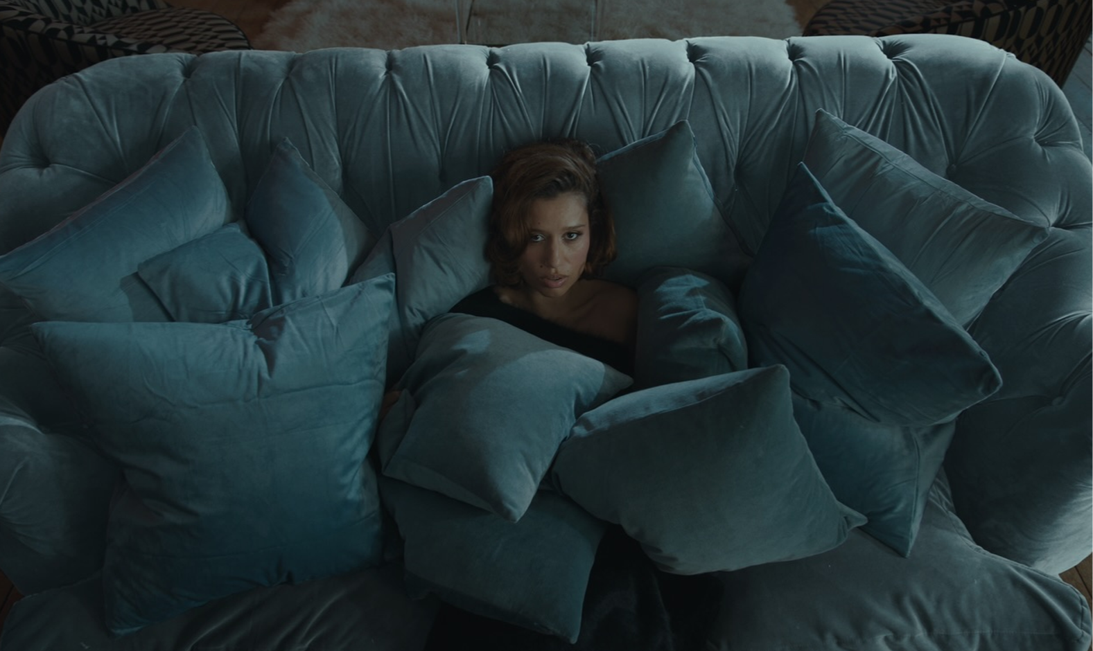 Woman sitting on a blue couch.