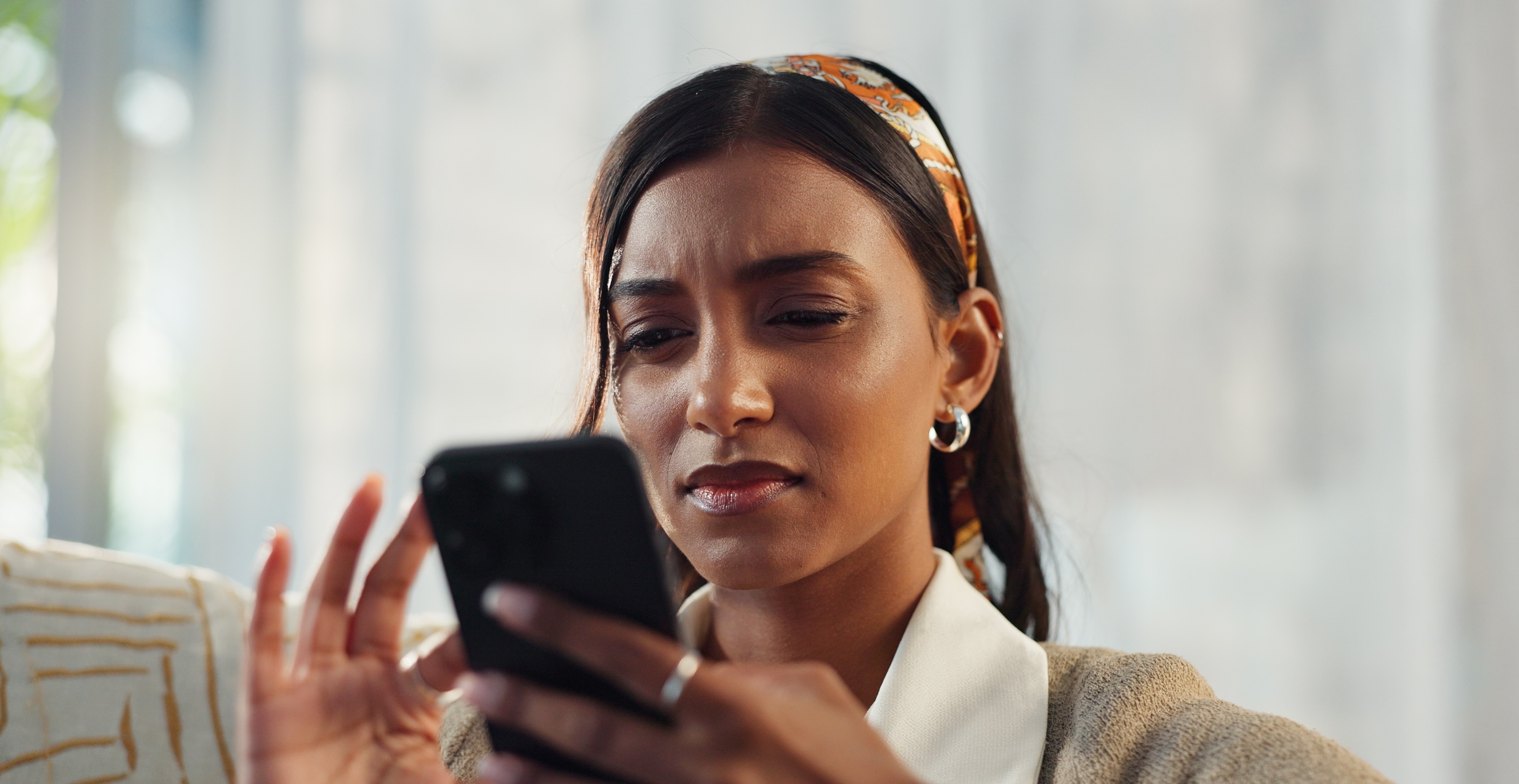 Woman frowning at her phone
