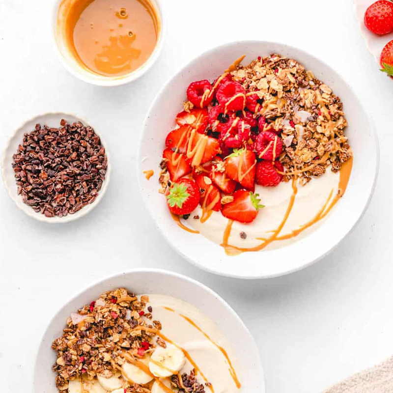Yogurt bowls with peanut butter, granola, and fruit.