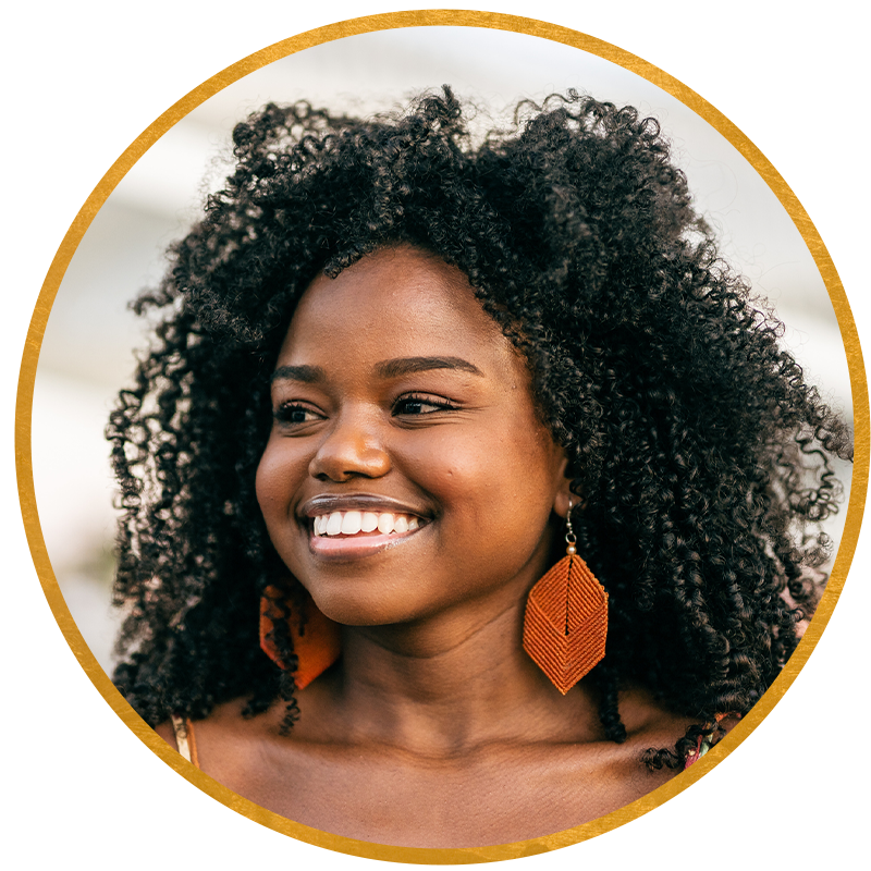 Curly haired woman smiling.