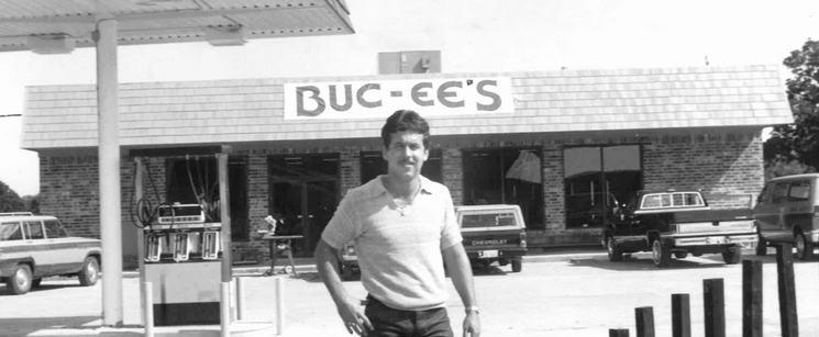 Old Buc-ee’s storefront with a person standing outside.
